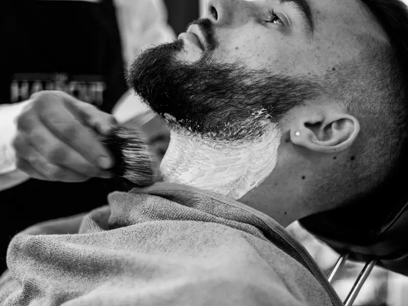 Barba com espuma sendo preparada para a navalha